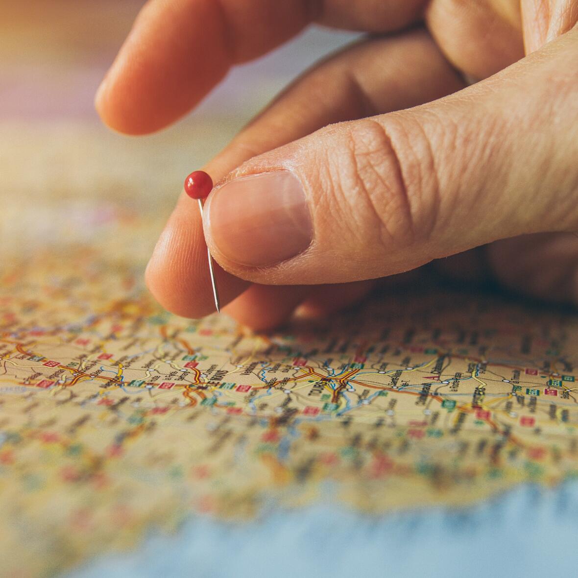 canva-hand-pinning-country-in-a-map